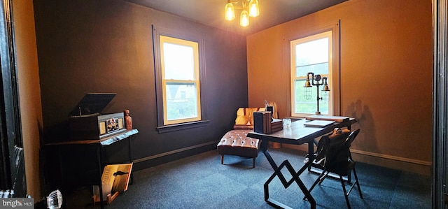 carpeted office space featuring baseboards
