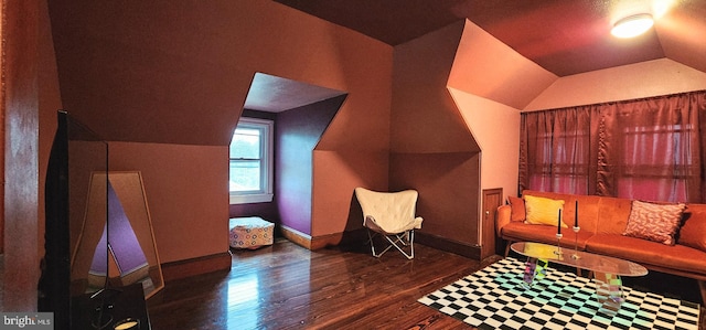 sitting room with wood finished floors, vaulted ceiling, and baseboards