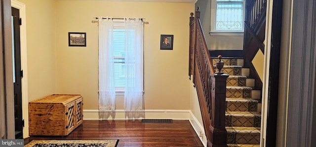 staircase with wood finished floors and baseboards