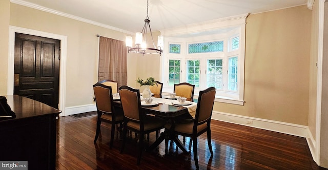 dining space featuring baseboards, a chandelier, dark wood-type flooring, and ornamental molding