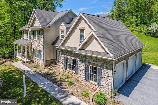 304 Iron Valley Dr, Lebanon, PA 17042 - view of front of house with stone siding, stucco siding, a garage, and a front yard