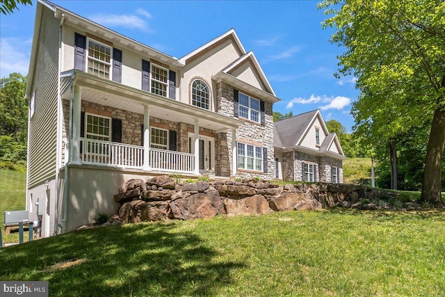 304 Iron Valley Dr, Lebanon, PA 17042 - view of front of property featuring stone siding, covered porch, a front lawn, and stucco siding