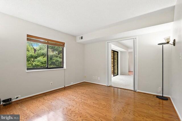 unfurnished room featuring light wood-style floors and baseboards