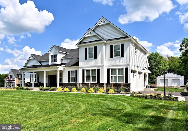 130 Schultz Rd, Sellersville, PA 18960 - view of front of home with a front lawn, a garage, covered porch, a shingled roof, and board and batten siding