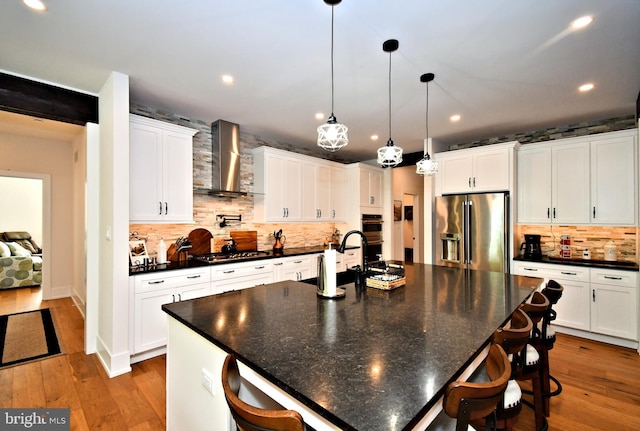 130 Schultz Rd, Sellersville, PA 18960 - kitchen featuring stainless steel appliances, wall chimney range hood, dark countertops, decorative backsplash, and recessed lighting