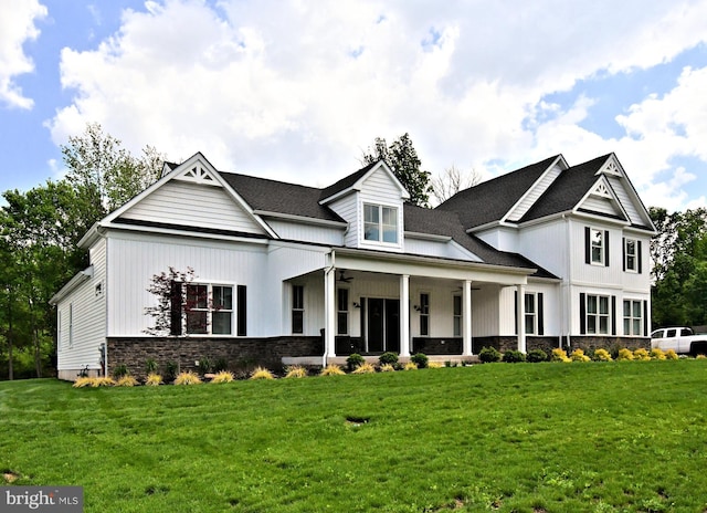 130 Schultz Rd, Sellersville, PA 18960 - view of front of house featuring ceiling fan, a front lawn, stone siding, and board and batten siding