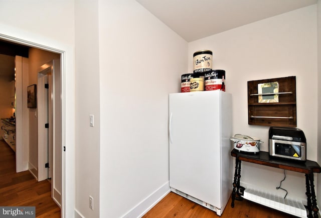 130 Schultz Rd, Sellersville, PA 18960 - hall featuring a baseboard heating unit, wood finished floors, and baseboards