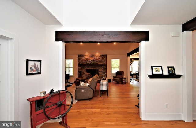 130 Schultz Rd, Sellersville, PA 18960 - living room featuring light wood-style flooring, beam ceiling, baseboards, and a stone fireplace