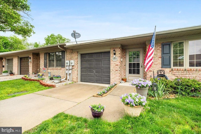 ranch-style house featuring an attached garage, driveway, and brick siding