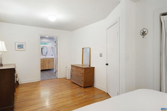 5629 Fitzgerald Rd, Charlottesville, VA 22903 - bedroom featuring light wood finished floors, a sink, baseboards, and ensuite bathroom