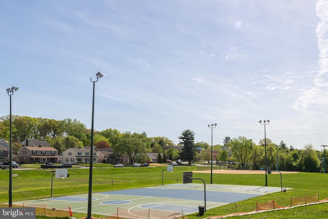 view of sport court with a lawn, community basketball court, and a residential view