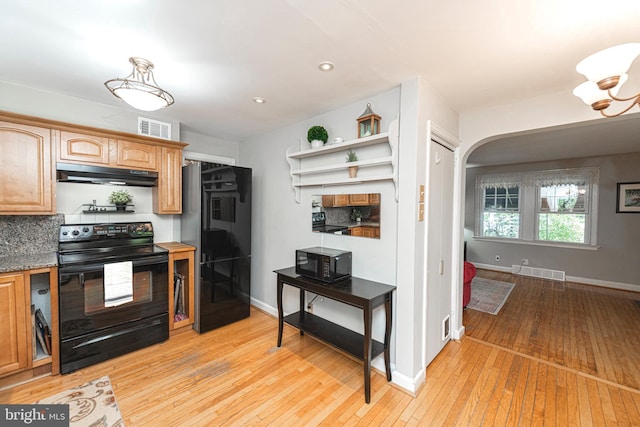 kitchen featuring black appliances, under cabinet range hood, light wood finished floors, baseboards, and recessed lighting