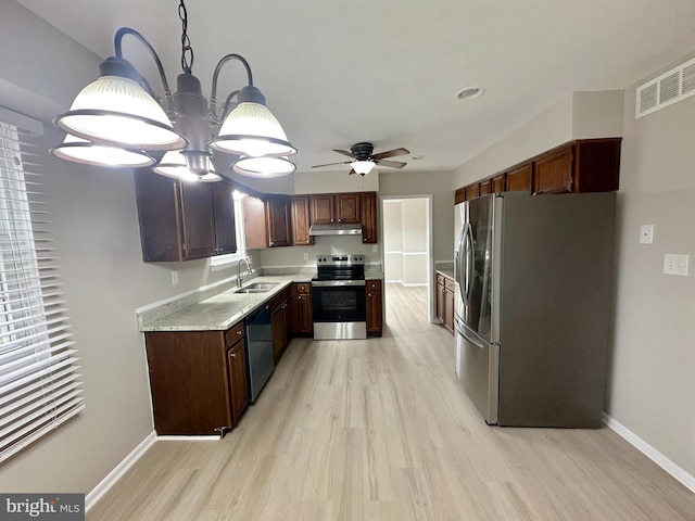 kitchen with stainless steel appliances, light wood-type flooring, baseboards, and under cabinet range hood