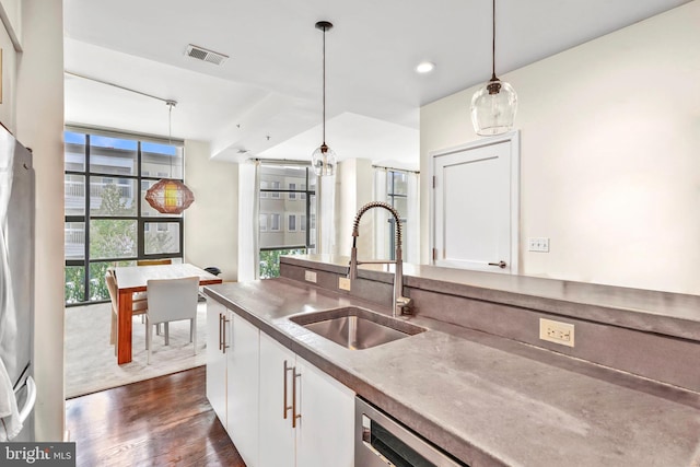 kitchen with a sink, plenty of natural light, and white cabinets