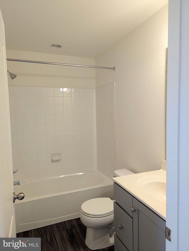 full bathroom featuring vanity, toilet, bathing tub / shower combination, and wood finished floors