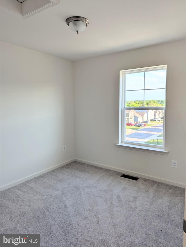 carpeted empty room with baseboards
