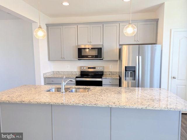 kitchen with stainless steel appliances, a sink, gray cabinets, pendant lighting, and recessed lighting