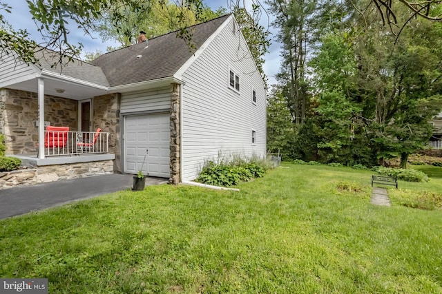 view of side of property featuring a lawn, a shingled roof, a chimney, and stone siding