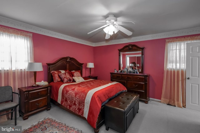 bedroom featuring light colored carpet and ceiling fan