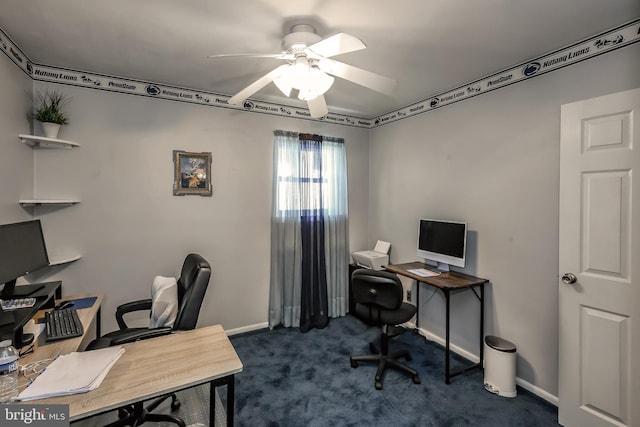 office with a ceiling fan, dark carpet, and baseboards