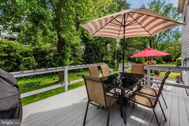 wooden terrace with outdoor dining space
