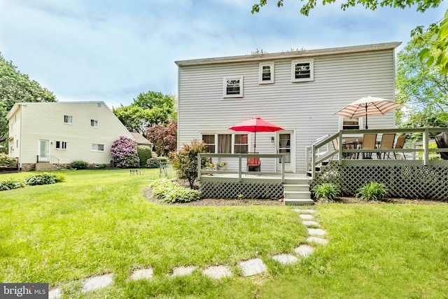 back of house with a yard and a wooden deck