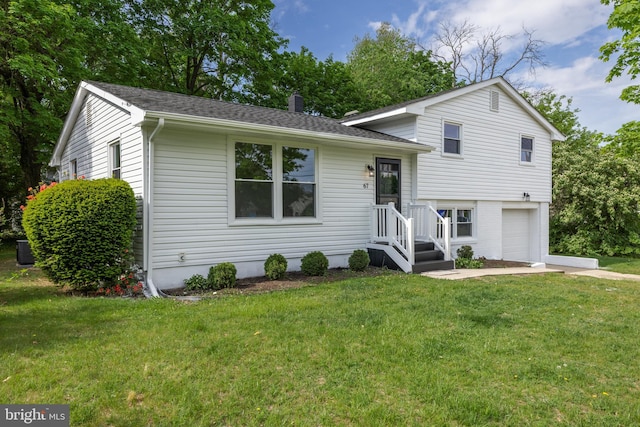 split level home with a garage, a front lawn, a chimney, cooling unit, and a shingled roof