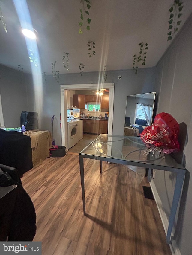home office featuring washer / clothes dryer and light wood-style floors