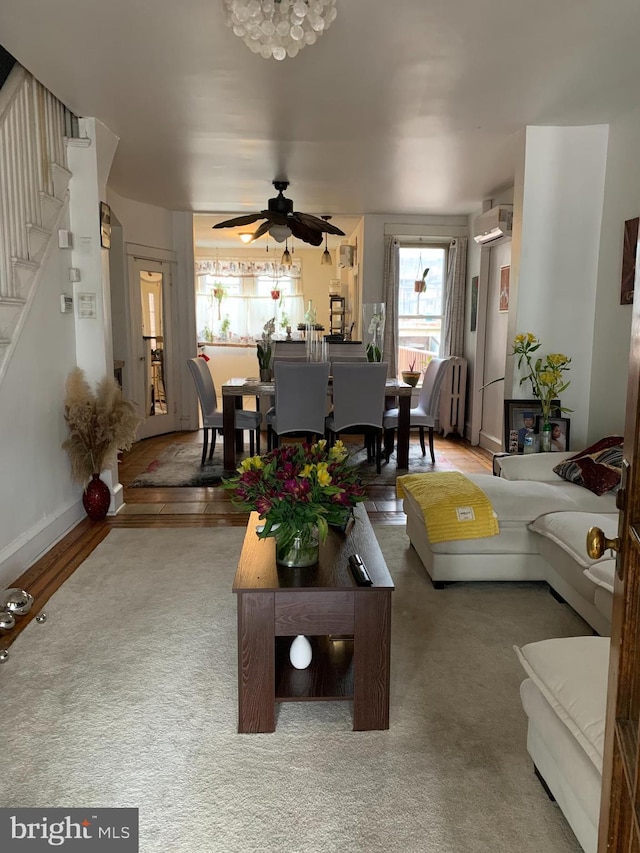 4808 Gransback St, Philadelphia, PA 19120 - living room with a ceiling fan, a wall mounted air conditioner, stairs, carpet, and baseboards