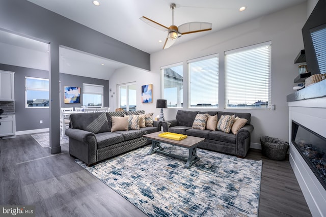 1308 E Bay Ave, Manahawkin, NJ 08050 - living area featuring vaulted ceiling, ceiling fan, recessed lighting, dark wood-style floors, and a glass covered fireplace