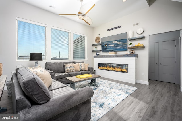 1308 E Bay Ave, Manahawkin, NJ 08050 - living area featuring ceiling fan, wood finished floors, a glass covered fireplace, and baseboards