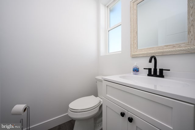 1308 E Bay Ave, Manahawkin, NJ 08050 - half bathroom featuring toilet, vanity, wood finished floors, and baseboards