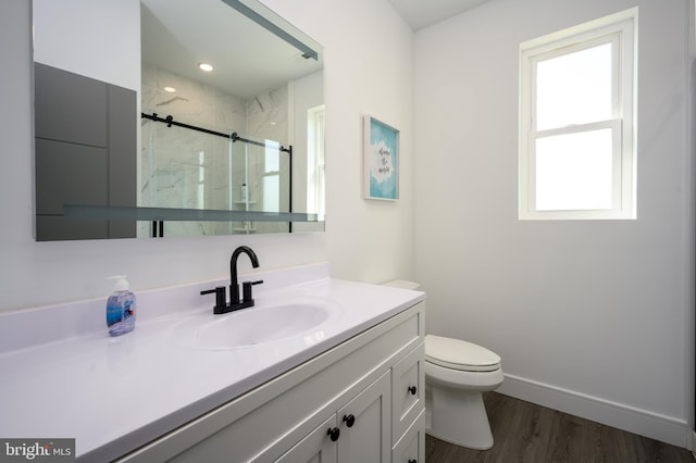 1308 E Bay Ave, Manahawkin, NJ 08050 - full bathroom with vanity, toilet, a marble finish shower, wood finished floors, and baseboards