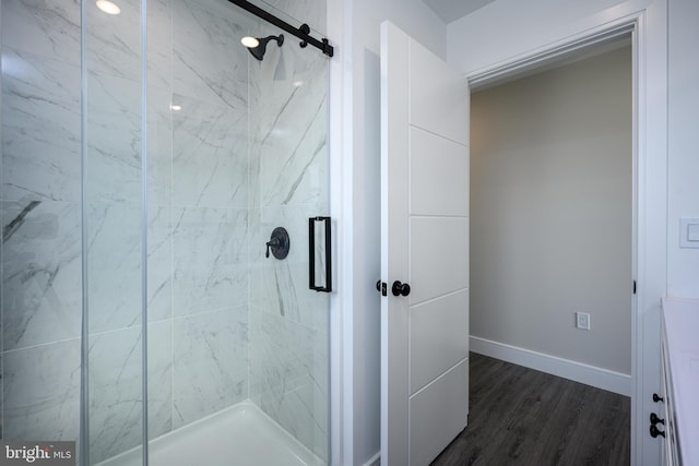 1308 E Bay Ave, Manahawkin, NJ 08050 - bathroom with a marble finish shower, baseboards, and wood finished floors