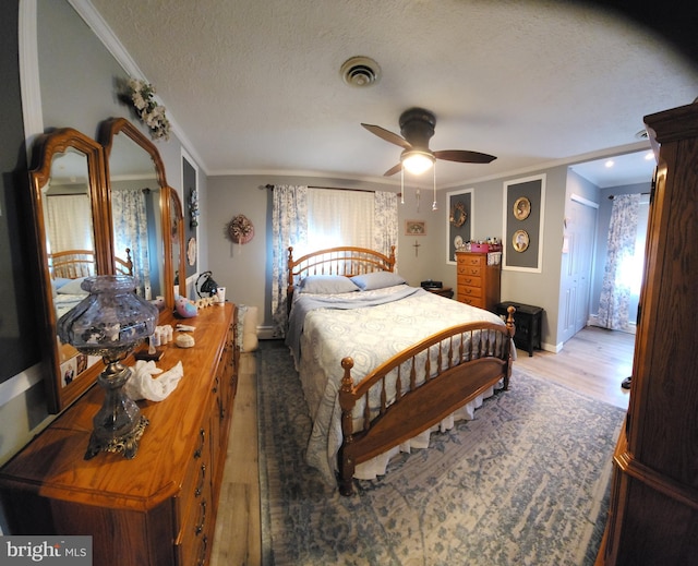 214 Alden Ave, Morrisville, PA 19067 - bedroom with crown molding, multiple windows, wood finished floors, a textured ceiling, and baseboards