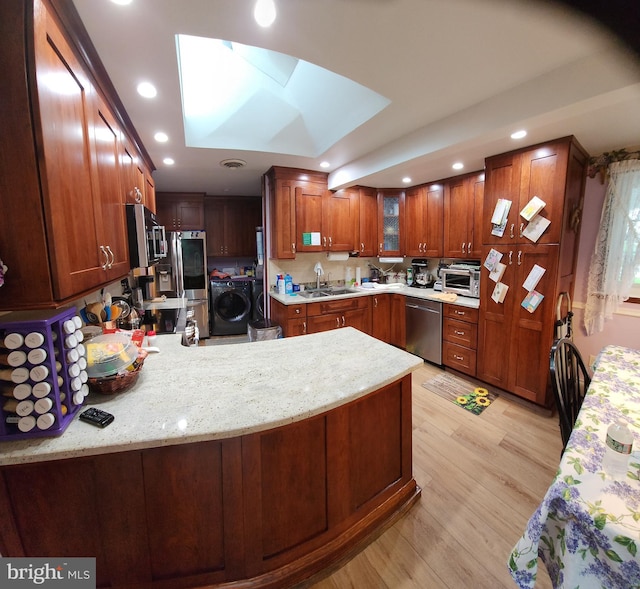 214 Alden Ave, Morrisville, PA 19067 - kitchen featuring washer / clothes dryer, appliances with stainless steel finishes, a sink, recessed lighting, and a peninsula