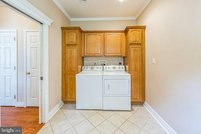 clothes washing area featuring cabinet space, independent washer and dryer, crown molding, baseboards, and light tile patterned flooring