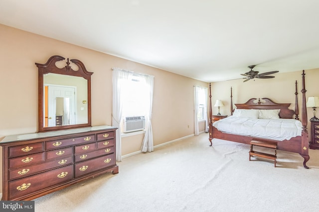 bedroom featuring multiple windows, light carpet, and baseboards