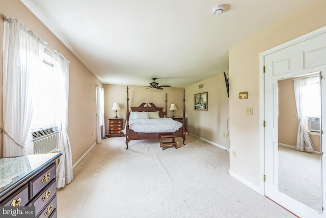 bedroom with light carpet, baseboards, cooling unit, and a ceiling fan