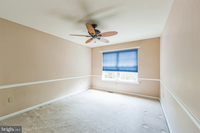 unfurnished room with a ceiling fan, carpet flooring, and baseboards