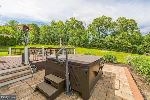 view of patio with a hot tub, a wooden deck, and view of scattered trees