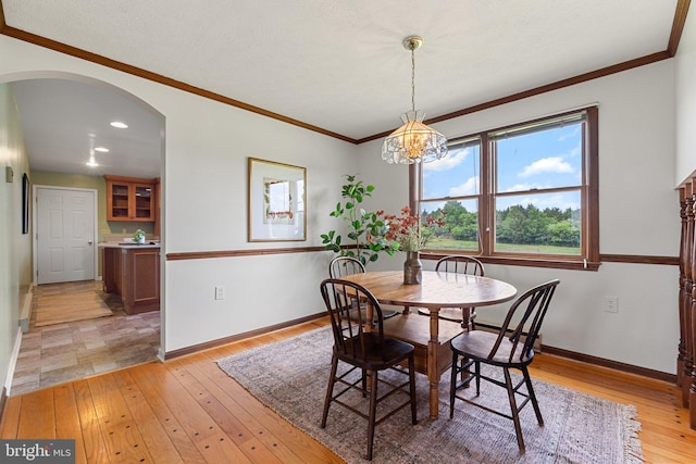 190 Chrismore Rd, White Post, VA 22663 - dining area featuring arched walkways, light wood finished floors, crown molding, a chandelier, and recessed lighting