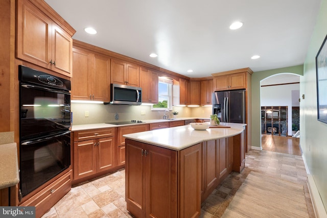 190 Chrismore Rd, White Post, VA 22663 - kitchen featuring black appliances, arched walkways, light countertops, a center island, and recessed lighting