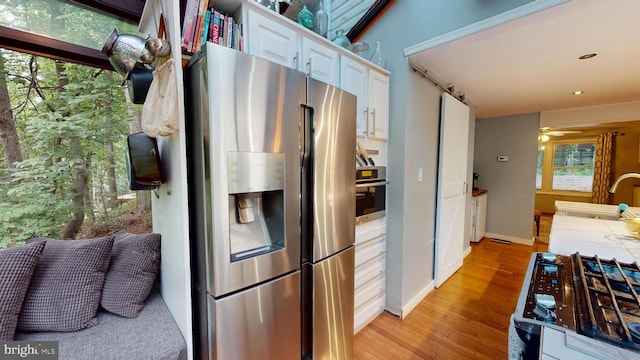 8609 N Dr, Clinton, MD 20735 - kitchen featuring appliances with stainless steel finishes, a sink, light wood-type flooring, baseboards, and ceiling fan
