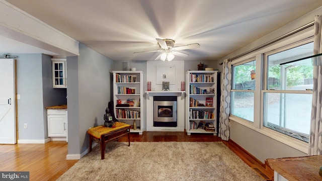 8609 N Dr, Clinton, MD 20735 - living area featuring wood finished floors, baseboards, and a ceiling fan