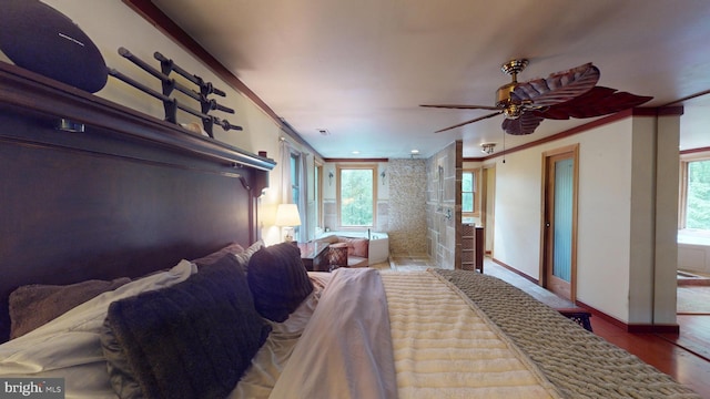 8609 N Dr, Clinton, MD 20735 - bedroom with wood finished floors, multiple windows, baseboards, and crown molding