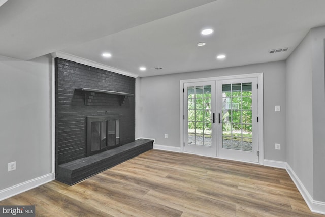 2218 Dairy Farm Rd, Gambrills, MD 21054 - unfurnished living room featuring wood finished floors, baseboards, recessed lighting, french doors, and a brick fireplace