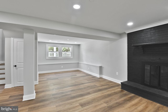 2218 Dairy Farm Rd, Gambrills, MD 21054 - below grade area with wood finished floors, baseboards, stairway, a brick fireplace, and recessed lighting