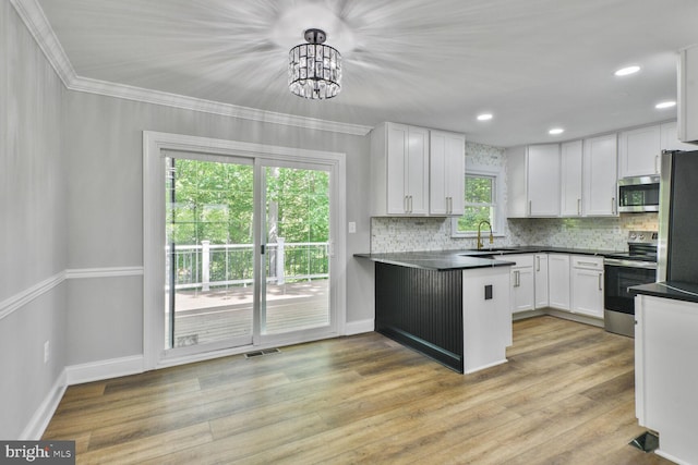 2218 Dairy Farm Rd, Gambrills, MD 21054 - kitchen with appliances with stainless steel finishes, a sink, a chandelier, white cabinets, and tasteful backsplash