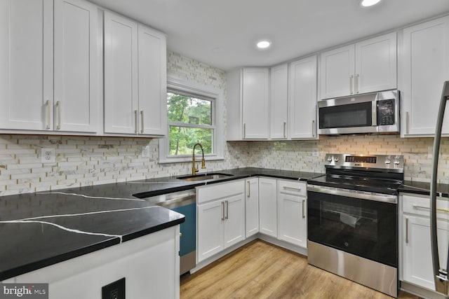 2218 Dairy Farm Rd, Gambrills, MD 21054 - kitchen featuring stainless steel appliances, a sink, white cabinetry, decorative backsplash, and recessed lighting
